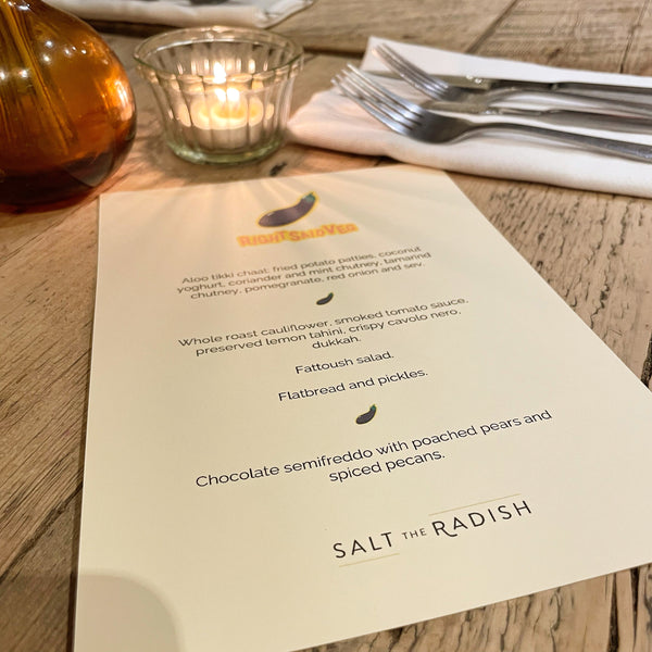 A copy of the Right Said Veg menu with a cutlery place setting and candle in the background.