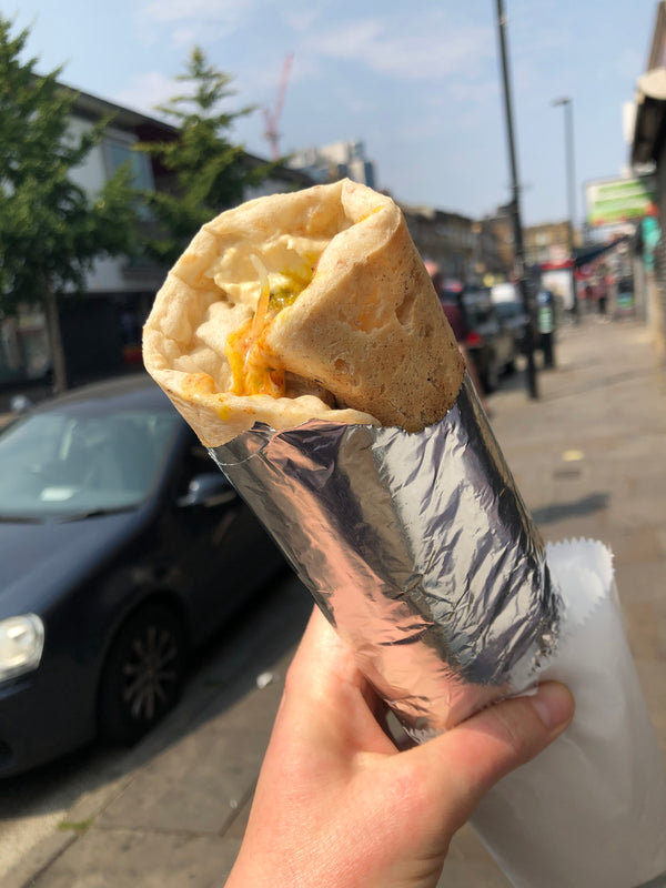 Baban's naan falafel wrap with Blackstock Road in the background.