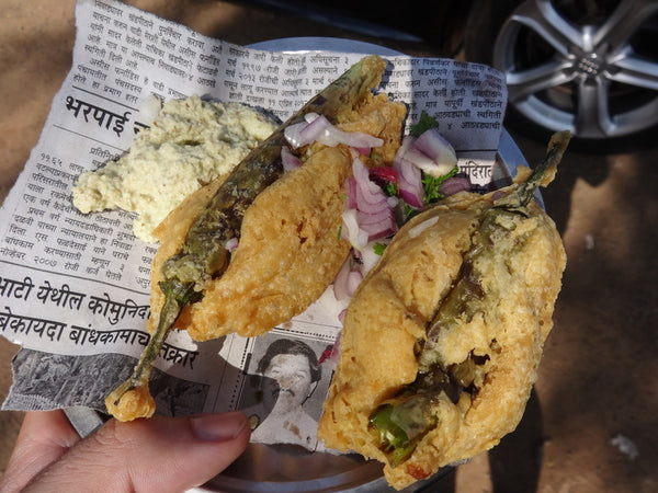 Deep fried green chilli in thick batter - a street food snack in India.