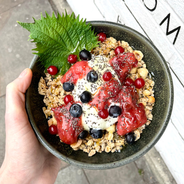 Seasonal granola dish: with hazelnut and sesame granola, rhubarb and strawberry compote, shiso leaf, Greek yoghurt and blueberry and redcurrant.