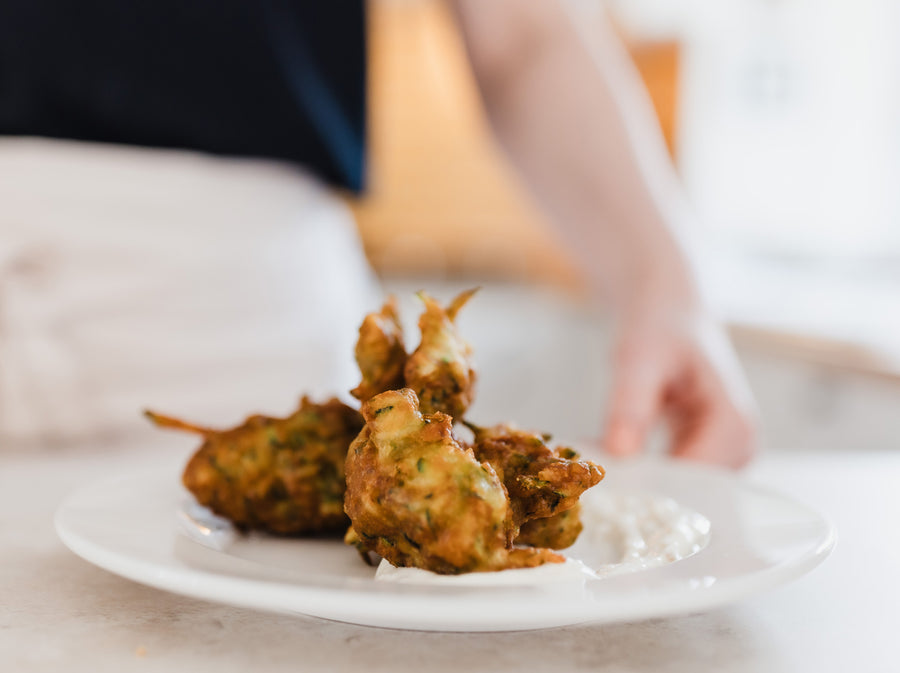 Deep fried courgette fritters on a yoghurt base.