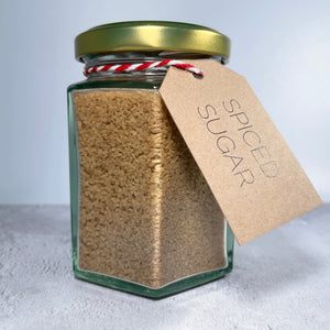 Glass jar containing our spiced sugar mix with a label.