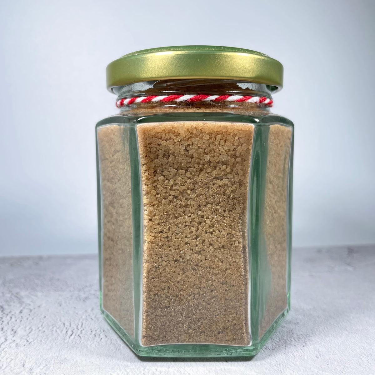 Side view of glass jar containing spiced sugar.