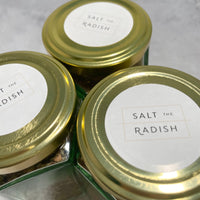 Top view of three spice jars showing the Salt the Radish logo on stickers.